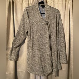 Grey long sleeved cardigan. Fastens on left shoulder with one button.